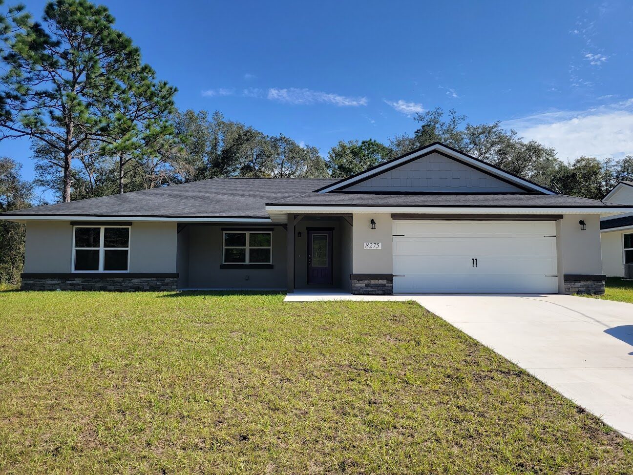 Newly completed gray modern single-family home on a quiet Citrus Springs street.