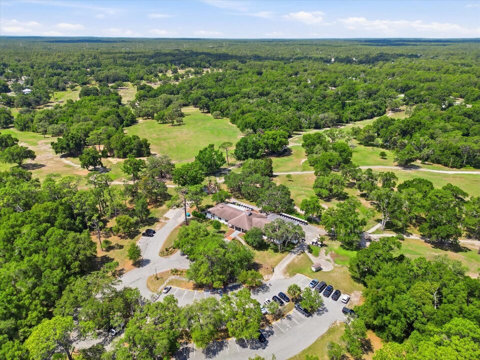 Aerial view of the Citrus Springs Golf and Country Club showing fairways, the clubhouse, and parking lot.