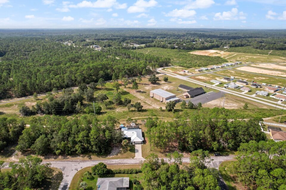 Drone view of Citrus Springs showing existing homes, vacant lots, and new construction in progress.