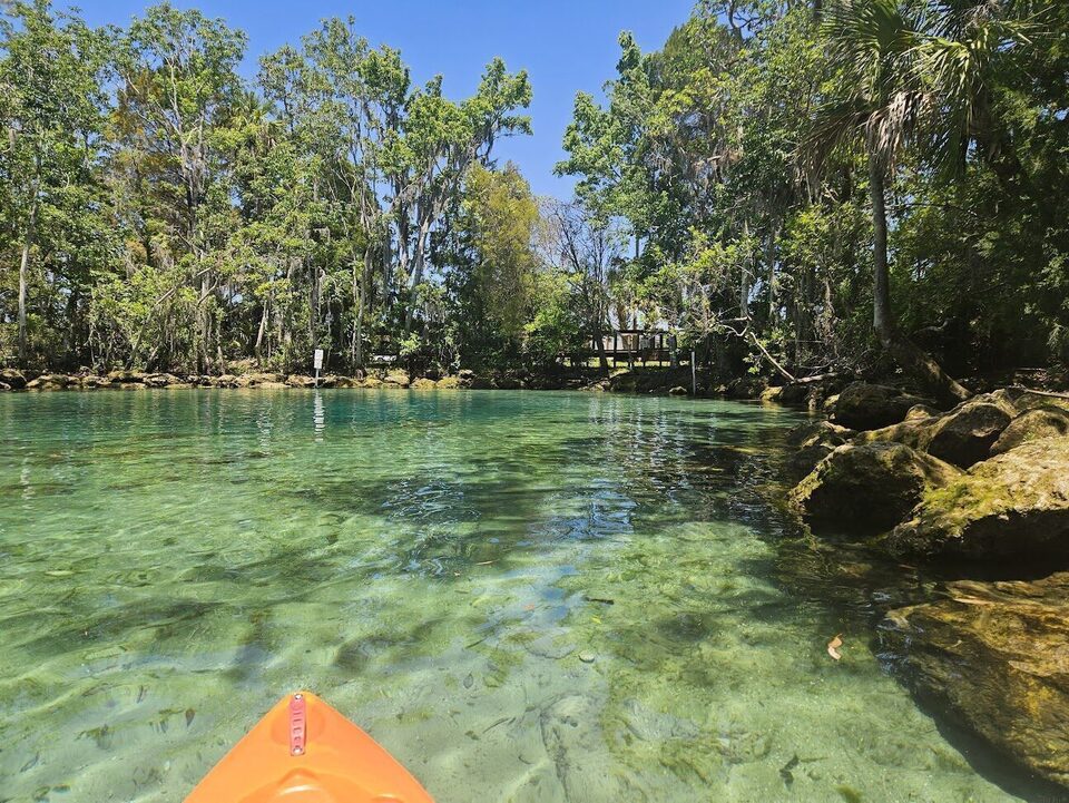 Kayak drifting on the clear turquoise water of Three Sisters Springs in Crystal River.
