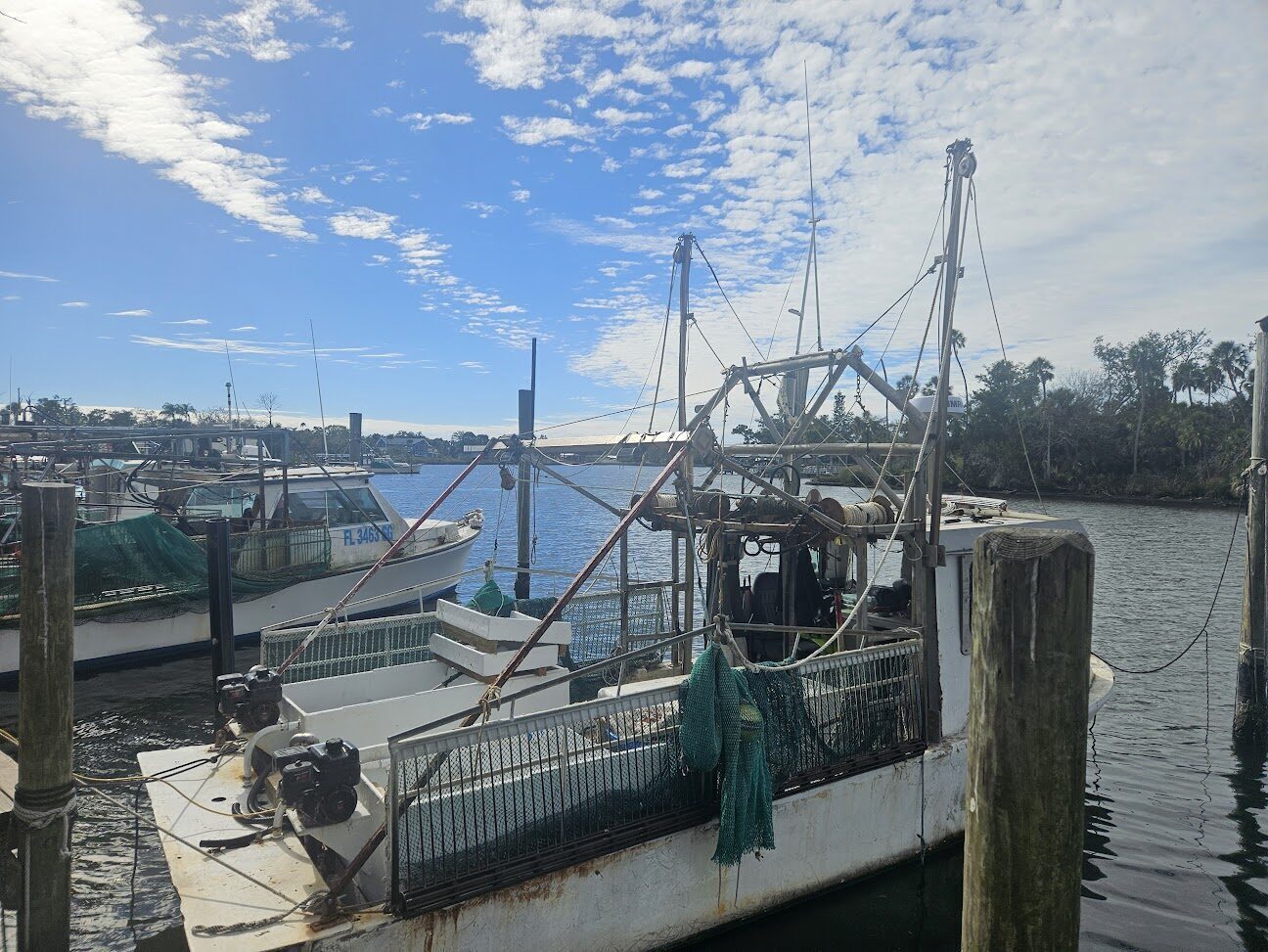 Commercial fishing trawler tied up at a working-waterfront dock on the Homosassa River.