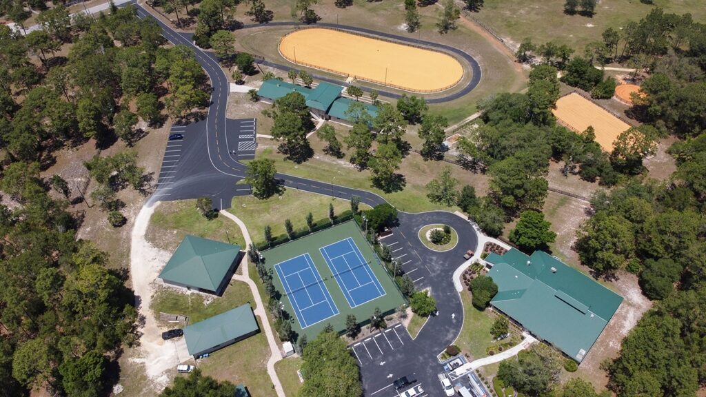 Aerial view of the Pine Ridge Community Center showing tennis courts, equestrian arena, and clubhouse.